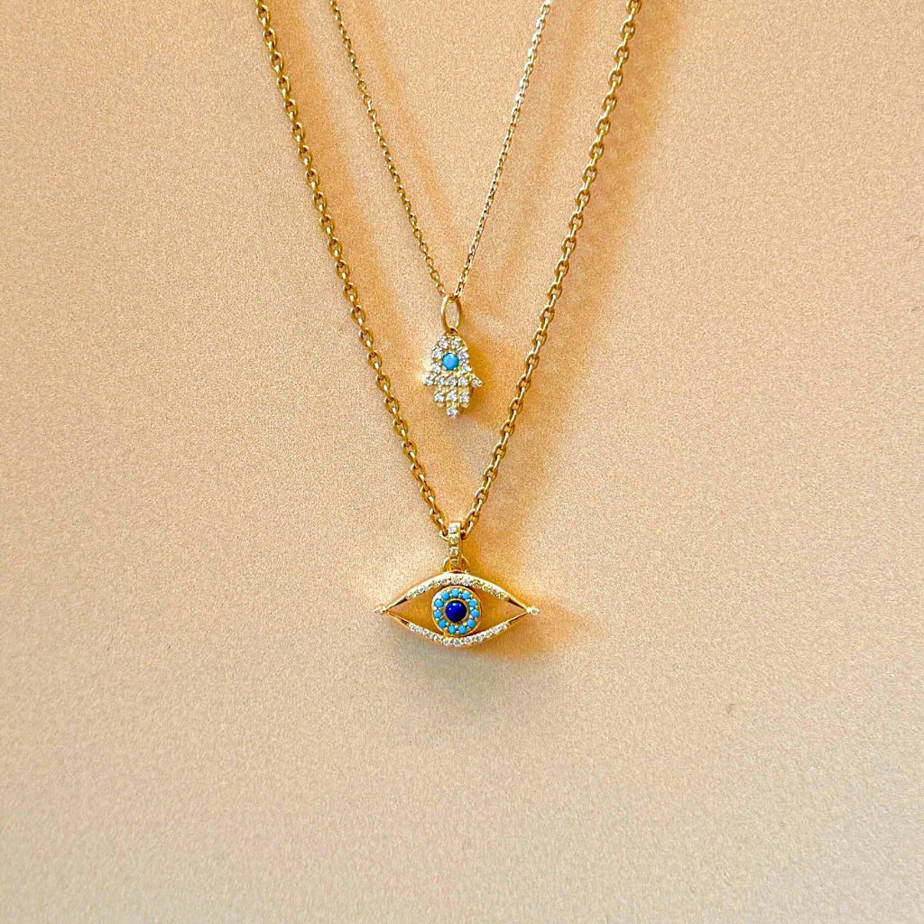 evil eye pendant styled with hand of hamsa